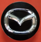 TAPON CENTRO RIN MAZDA VARIOS MODELOS NEGRO CON CROMO 57 MM ORIGINAL USADO 1 PZA
